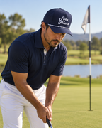 Golfer putting in a Fore Alarm navy and white rope hat